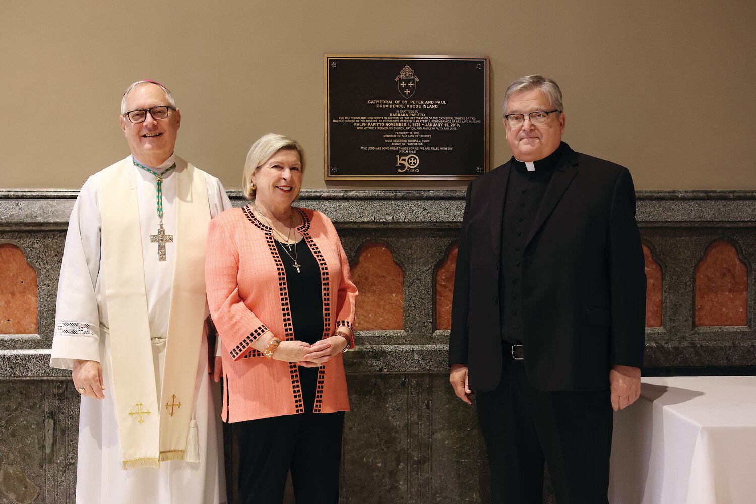 A plaque was installed and blessed in the Cathedral of SS. Peter and Paul, honoring years of dedicated support for the local church by Barbara Papitto and her late husband Ralph, a successful local businessman. Their support includes a $4.5 million donation to the cathedral enabling the recent restoration of its towers to be completed. Pictured, Bishop Thomas J. Tobin, Barbara Papitto and Msgr. Anthony Mancini, rector of the Cathedral of SS. Peter and Paul.